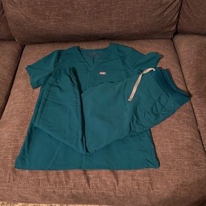 Two sets of medium figs scrubs